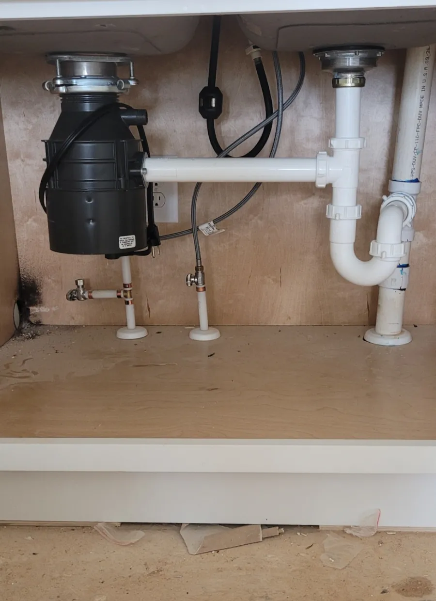 Neatly installed garbage disposal and drain plumbing